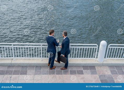 Two Business Men Discussing Outdoor During Business Meeting