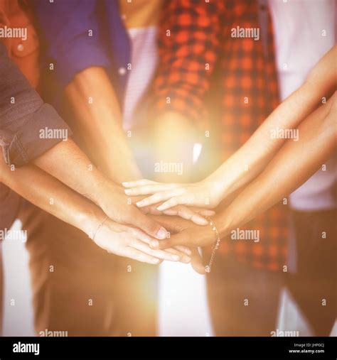 Mid Section Of Business People Stacking Hands In Office Stock Photo Alamy