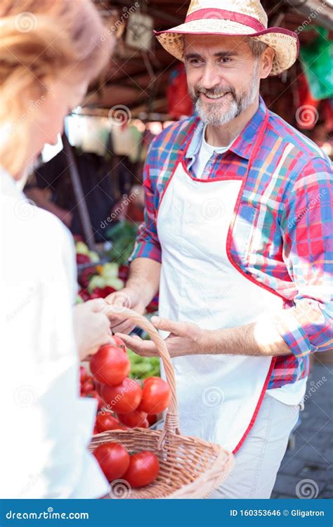 Happy Senior Farmer Selling His Organic Vegetables On A Local