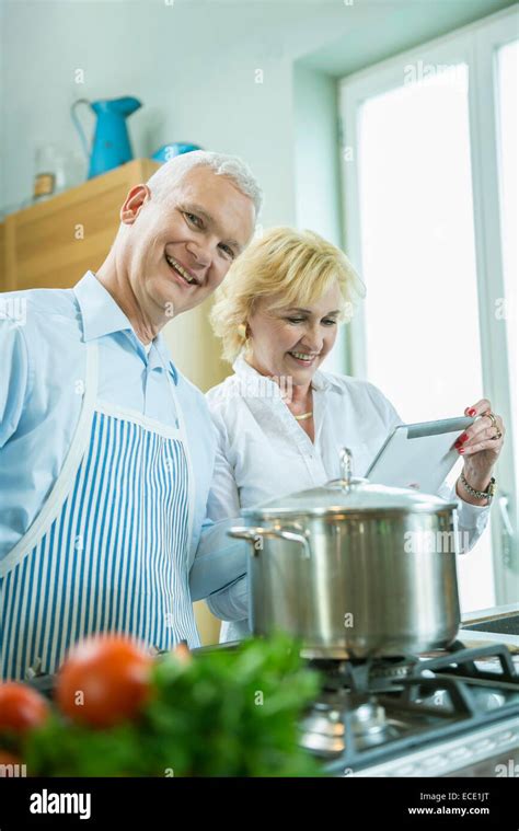 Mature Woman Cooking In Kitchen High Resolution Stock Photography And Images Alamy
