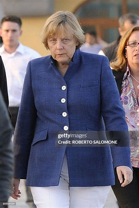 German Prime Minister Angela Merkel walks in a street of Sant Angelo ...