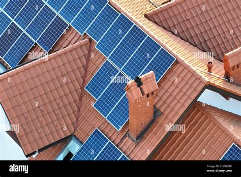 Aerial View Building Roof With Rows Of Blue Solar Photovoltaic Panels