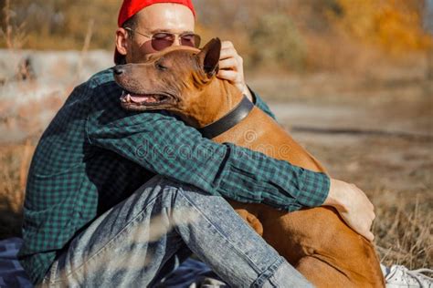 Man Hugging His Dog Outdoors Stock Photo Stock Photo - Image of young ...