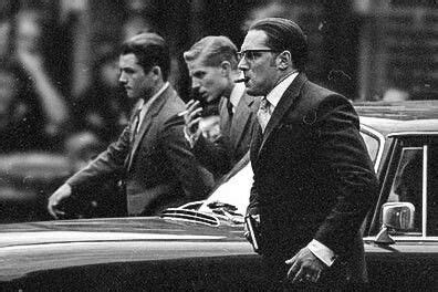 Three Men In Suits And Ties Standing Next To A Car