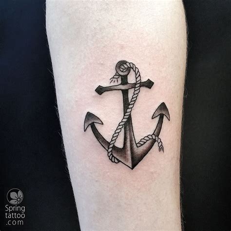 a black and white anchor tattoo on the right leg with rope around it's neck