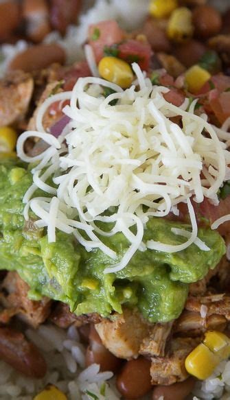 A Bowl Filled With Rice Beans And Guacamole On Top Of It