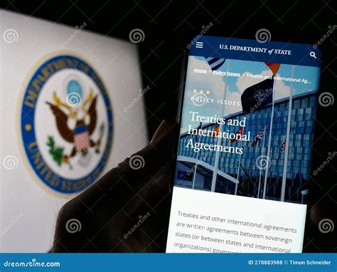 Person Holding Cellphone with Web Page of United States Department of ...