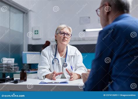 Doctor And Patient Meeting At Consultation Appointment To Do Healthcare