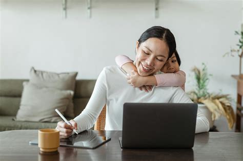 Happy mother working from home and little daughter hugging mom · Free