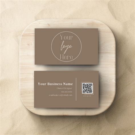 A Business Card On A Wooden Plate With A Qr Code In The Middle And A