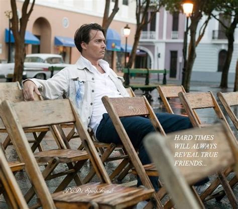 A Man Sitting On Top Of Wooden Chairs