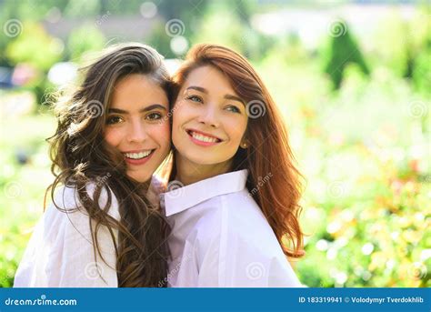 Friend Girls Forever. Two Cute Lovely Girl Friends Posing with Smile on Green Spring Background ...