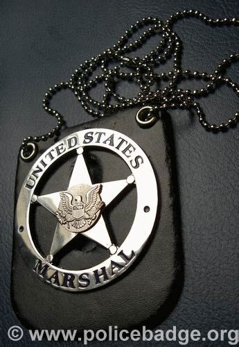 US Marshals Badge on Black Leather Surface