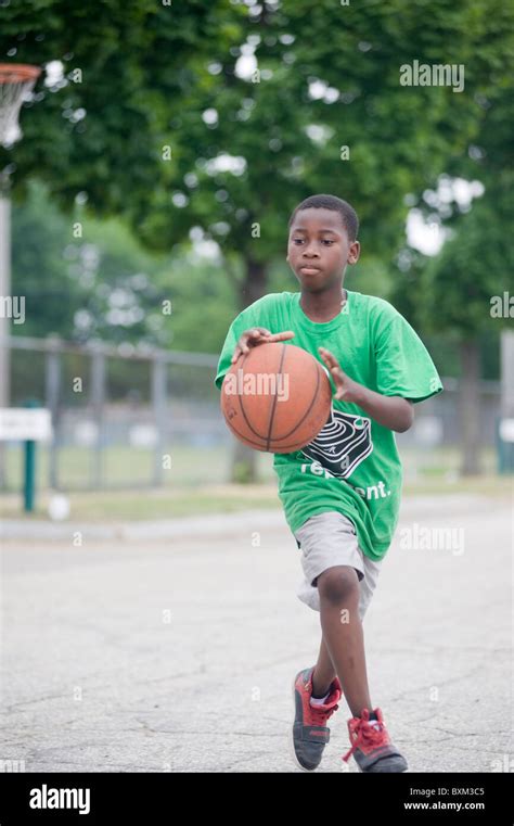 Elementary school boys and girls play basketball with fellow students ...