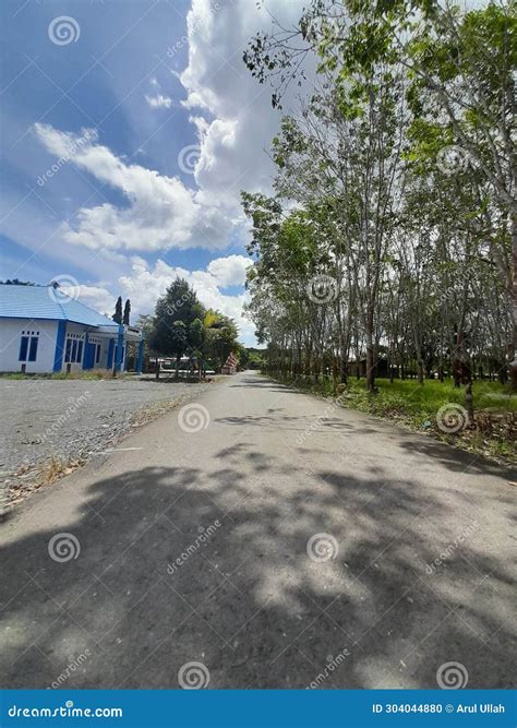 A Straight Road without Seeing Trees and Standing Houses Stock Photo