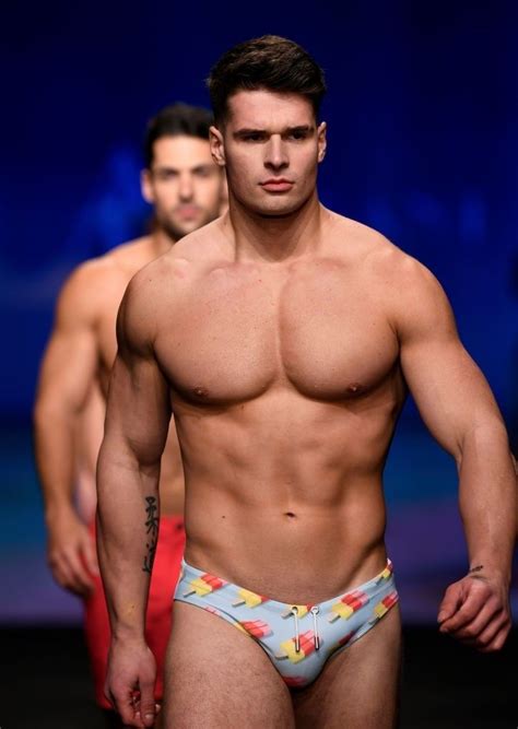 A Man With No Shirt On Walking Down The Runway