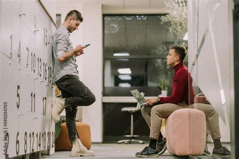 Good Looking Man Scrolling On His Phone After Work While His Male