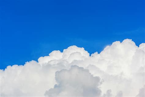 Turquoise Blue Sky with White Swirling Clouds · Free Stock Photo