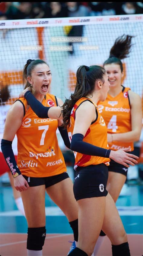 Three Women In Orange Uniforms Are Playing Volleyball