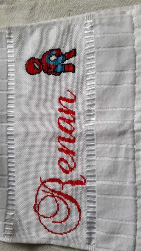 An Embroidered Name On A Towel With A Spiderman Figure In The Middle