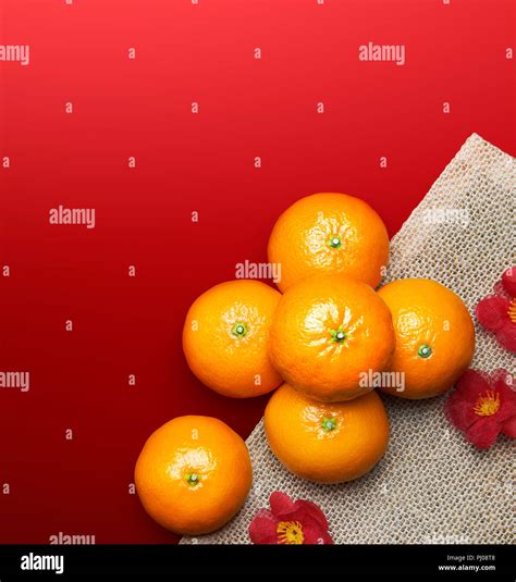 Chinese New Year - Mandarin oranges on red background Stock Photo - Alamy