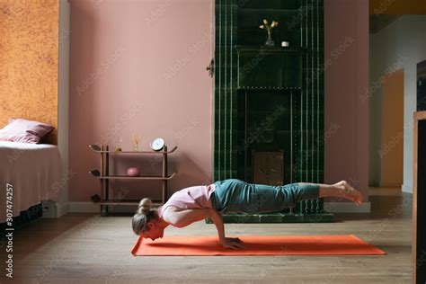 Strong Woman Practicing Peacock Pose Stock Photo | Adobe Stock