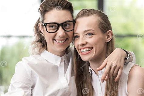 Happy Lesbian Couple Hugging Each Other And Looking Aside Stock Image