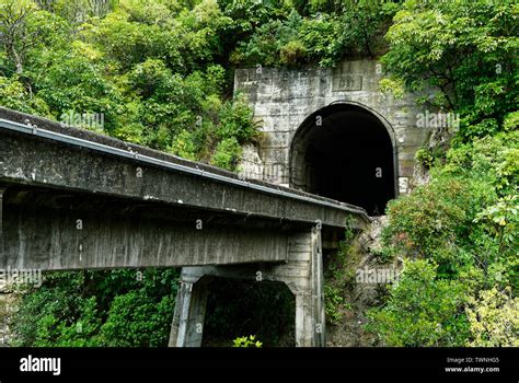 A tunnel in a hill in New Zealand for a train to go through, there is a ...