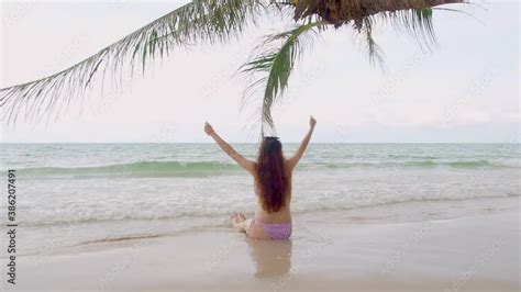 Sexy Asian Woman In Bikini Posture With Coconut Palm Leaf On Tropical