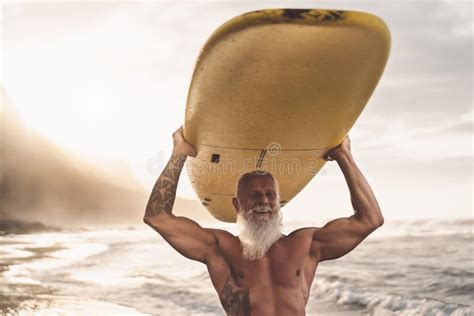 Happy Fit Senior Having Fun Surfing At Sunset Time Sporty Bearded Man