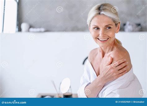 Smiling Senior Woman In Bathrobe Touching Her Naked Shoulder Stock Image Image Of Morning