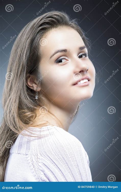 Portrait Of Sensual And Shy Positive Caucasian Brunette With Natural Long Hair Posing In Sweater