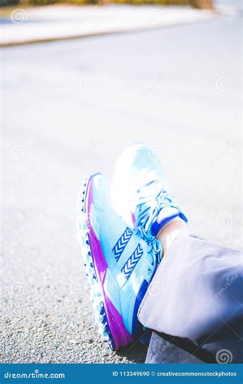 Person Wearing Pair Of Blue And Pink Running Shoes Picture Image