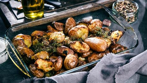 Baked Potatoes Whole In Their Skins With Thyme Rosemary And Garlic