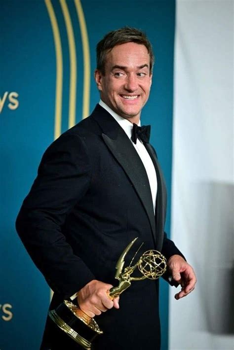 a man in a tuxedo holding an award for outstanding performance at the ...