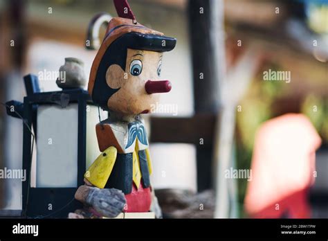 A colorful and abandoned Pinocchio with a Japanese lamp on its back ...
