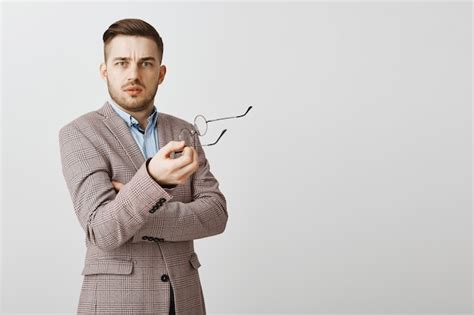 Free Photo Confused And Displeased Businessman Take Off Glasses And