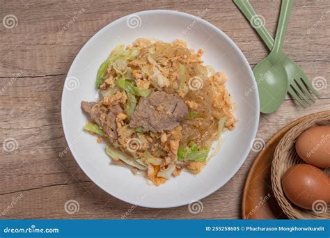 Stir Fried Vermicelli With Pork Egg And Collard Greens In A White