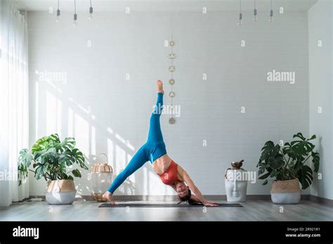 Woman Practicing Yoga Doing Standing Splits Pose Stock Photo Alamy