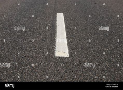 Asphalt road with single solid white line road marking Stock Photo - Alamy