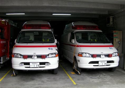 Two Ambulances Parked Next To Each Other