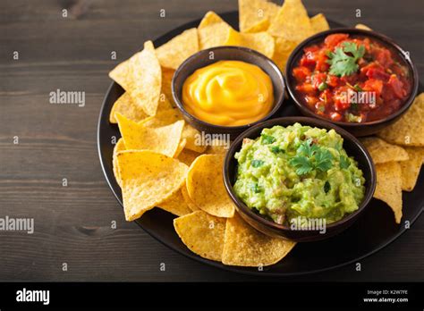 Mexican Nachos With Guacamole Salsa And Cheese Dip Stock Photo Alamy