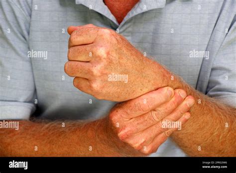 Fingers Of Right Hand Of A White Mature Male Massaging His Left Wrist