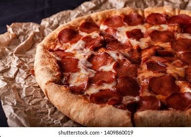 Pizza Peperoni On Black Stone Background Stock Photo