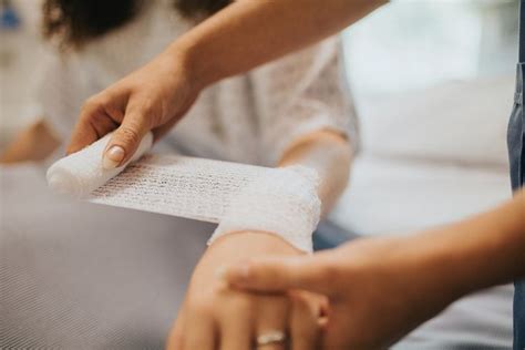 Nurse Bandaging The Patients Arm Premium Image By Rawpixel