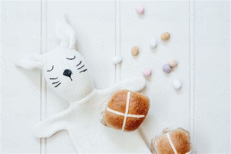 Image Of Hot Cross Buns With Mini Easter Eggs And Bunny Rabbit Puppet On White Background