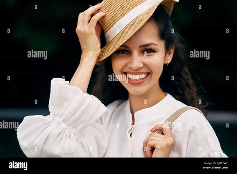 Portrait Of A Smiling Curly Haired Brunette Girl In A Hat Stock Photo Alamy