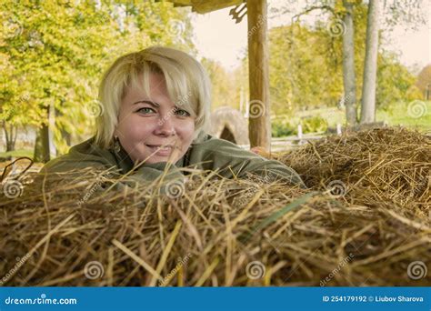 Blond Girl With Green Eyes In Nature Happy Middle Aged Woman On A Farm