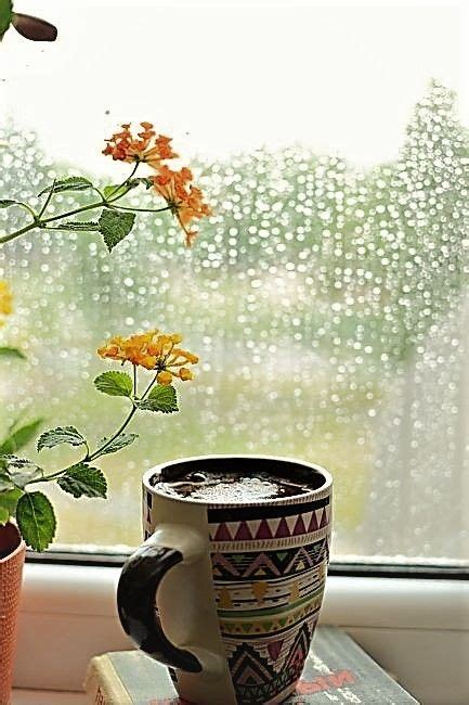 A Cup Of Coffee Sitting On Top Of A Book Next To A Window Sill