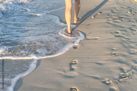 woman walking away on beach Stock Photo | Adobe Stock